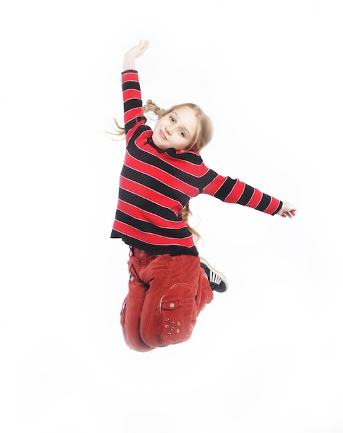 Little girl jumps on a white background