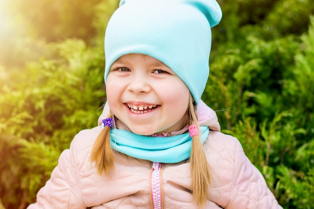 Little girl laughing and smiling in the park on the grass