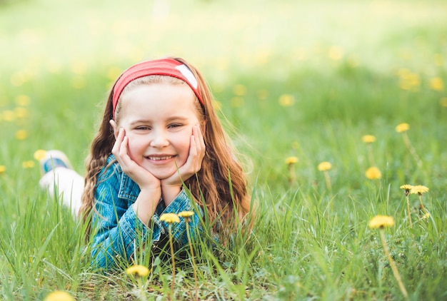 Little girl laying on grass