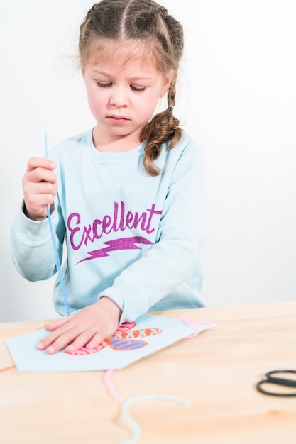 Little girl learning how to sew with sewing craft kit for kids