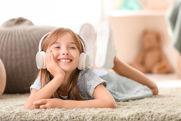 Little girl listening to music at home