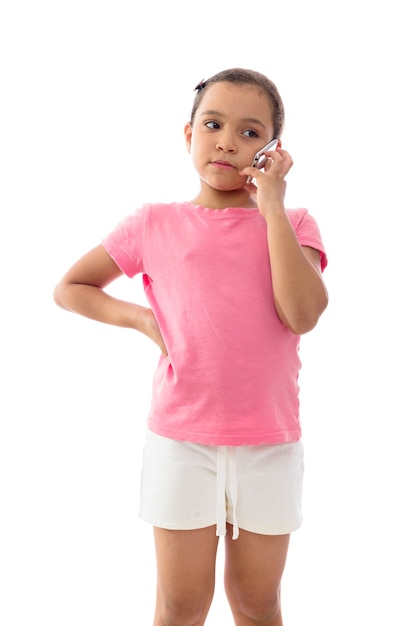 Little Girl Listening to a Phone Call on White Background