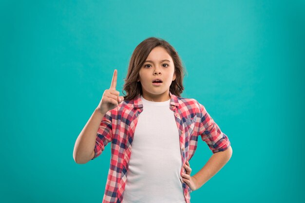 Little girl long hair got bright idea. Little child smile excited with new idea stand over blue background. This is the point. Idea solution. Girl cute concentrated face found out important idea.