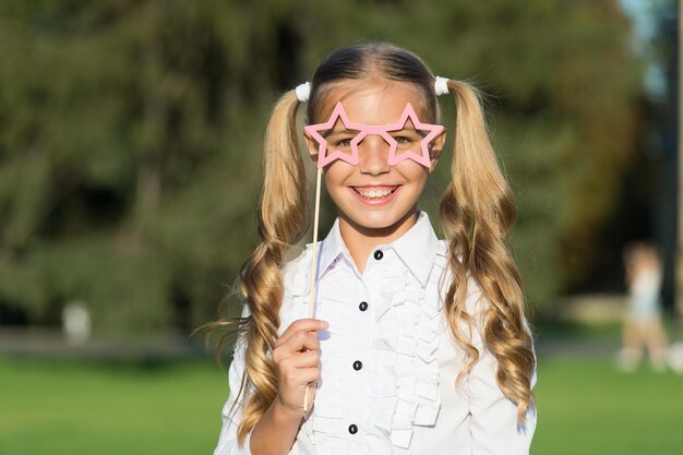 Little girl long hair hold star eyewear booth props happy holidays concept