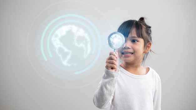 Little girl looking through a magnifying glass