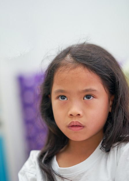 Little girl looking up worried facial expression