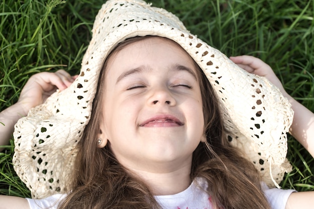 little girl lying in the grass. summer time and sunny day