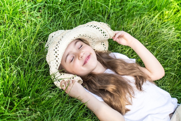 little girl lying in the grass. summer time and sunny day