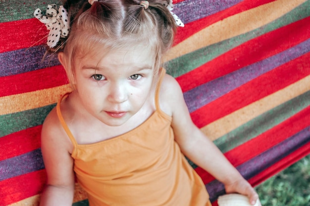 Little girl lying in a hammock