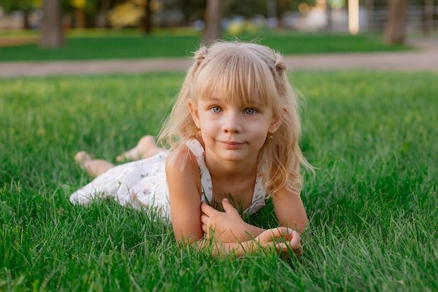 little girl lying on the lawn