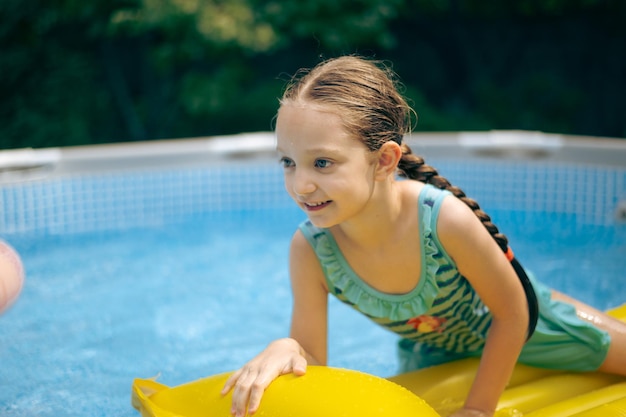 Little Girl Lying on Pool Float