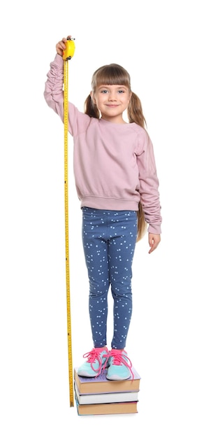 Photo little girl measuring her height on white background