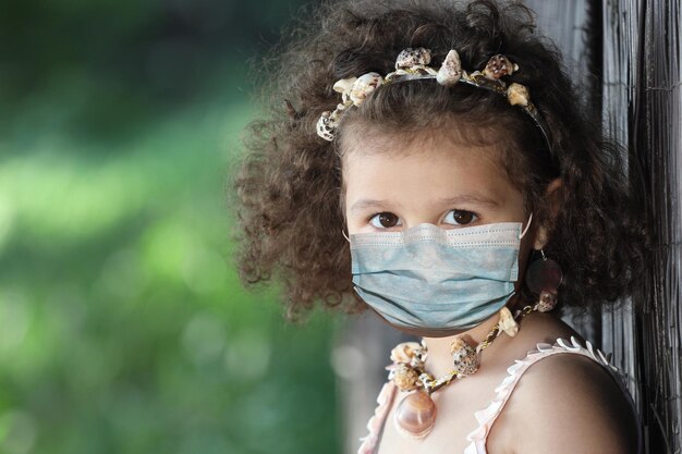 Little girl in a medical mask close up