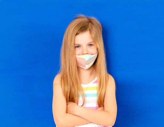 Little girl in a medical mask. mask prophylaxis to reduce the spread of coronavirus outbreaks (covid-19)