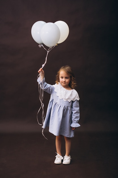 Little girl model studio with balloons