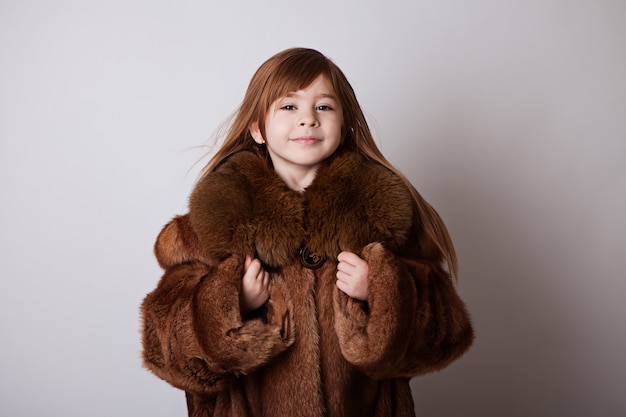 Little girl in my mother's brown long coat