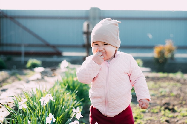 Little girl one year playing in the village outdoors