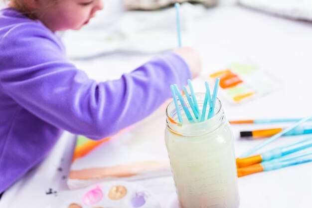 Little girl painting on canvas with arcylic paint