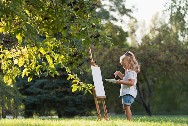 Little girl paints