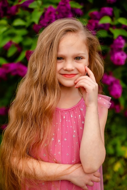 A little girl in a pink dress with stars on it