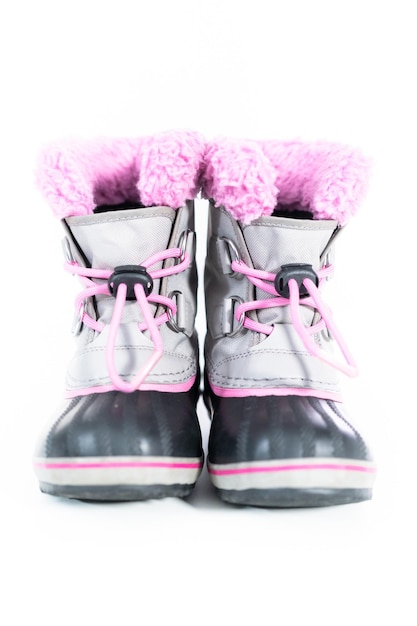 Little girl pink and gray warm and waterproof winter boots on a white background.