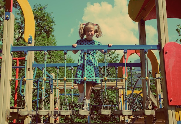 Little girl on playground vintage retro style