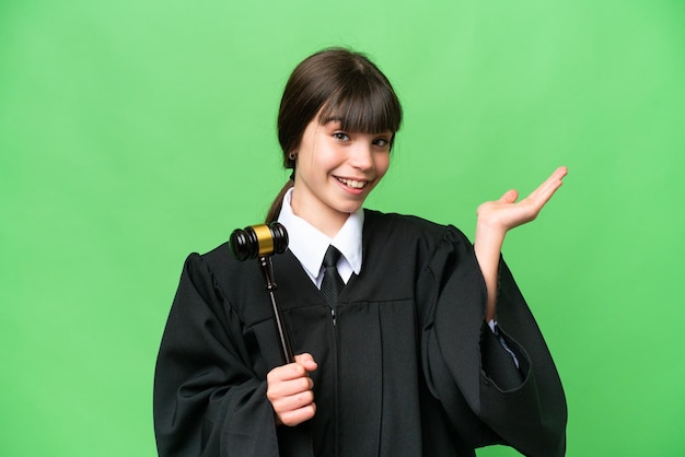 Little girl playing as a Judge over isolated background extending hands to the side for inviting to come