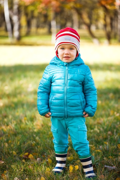 Little girl playing in autumn park