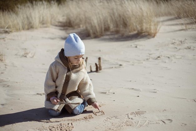 little girl playing by the ocean