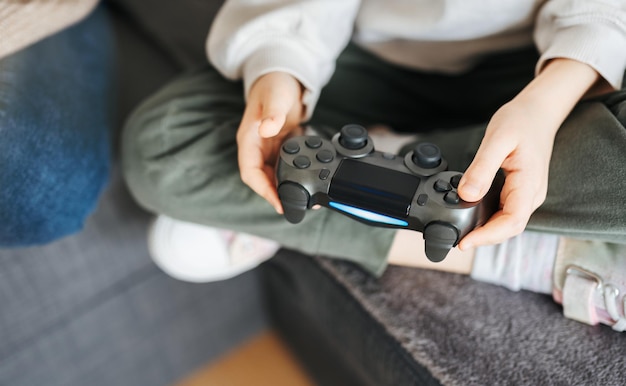 Little girl playing on games console