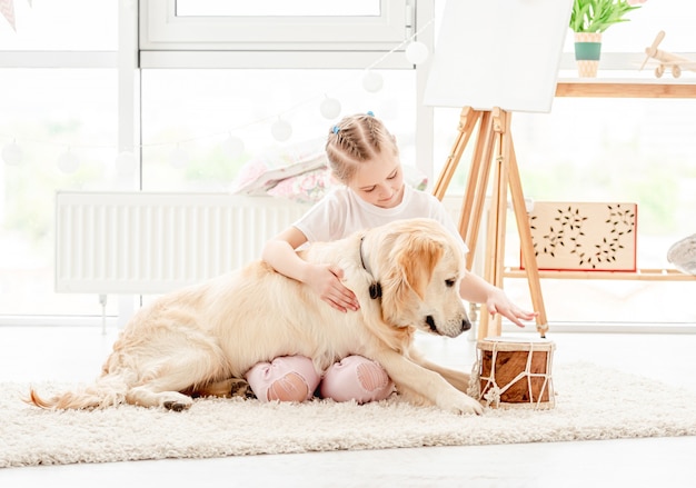 Little girl playing music with dog