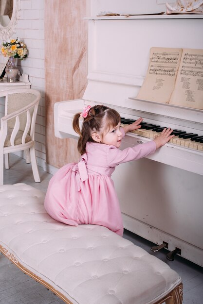 Little girl playing piano at home