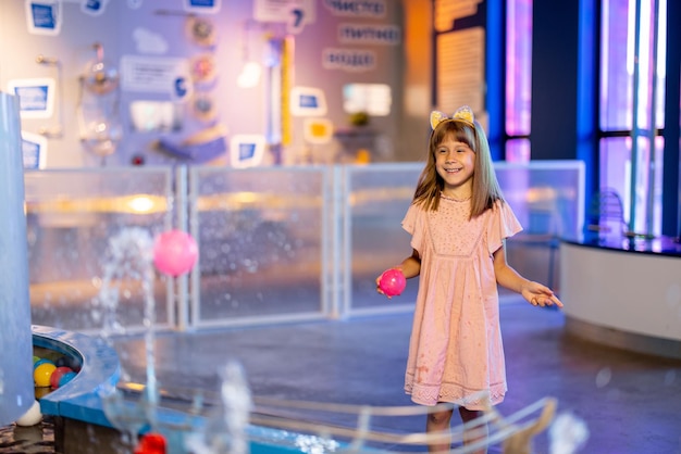 Little girl playing in a science museum