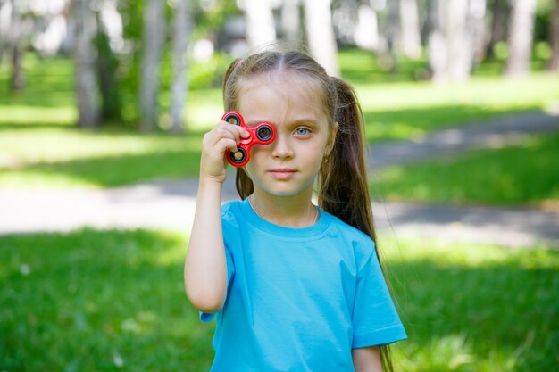 Little girl playing with fidget spinner