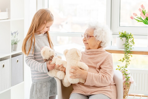 Little girl playing with her grandmother