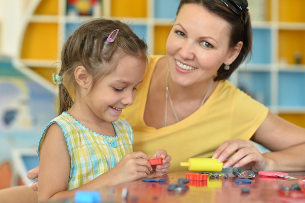 Little girl playing with her mother at home