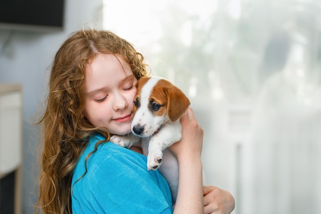 子犬ジャックラッセルで遊んでいる少女