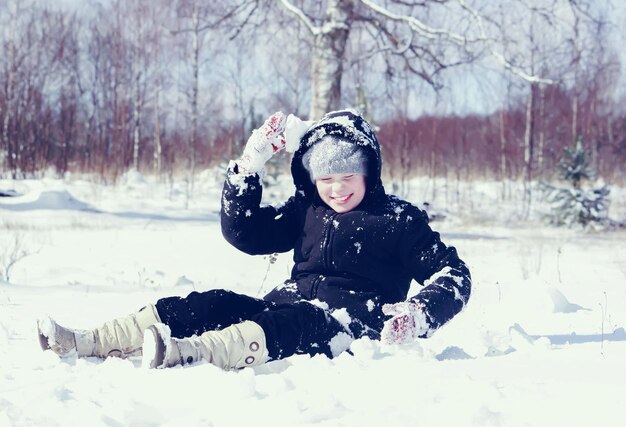 A little girl playing with snow