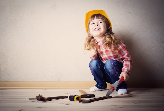 Little girl plays in the builder