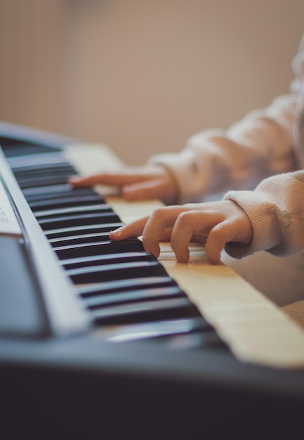 A little girl plays the electric piano