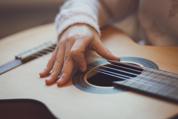 Little girl plays the guitar