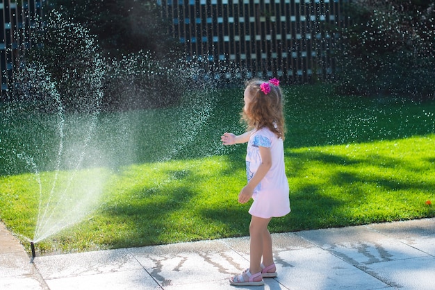 Little girl plays with splashes.