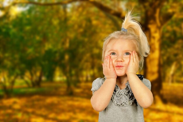 Little girl portrait in the autumn park