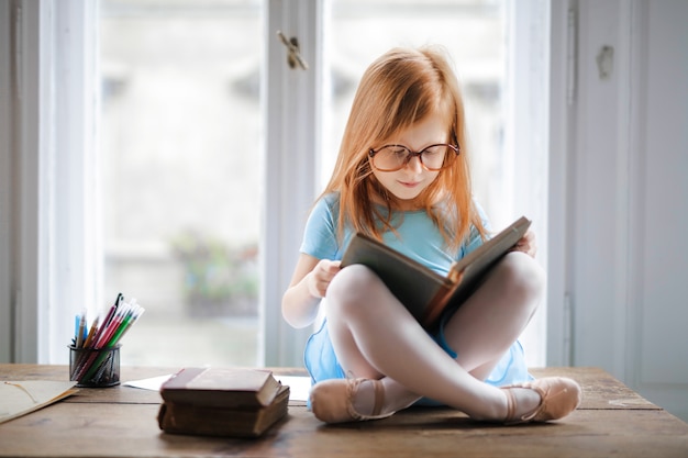 Little girl reading a book