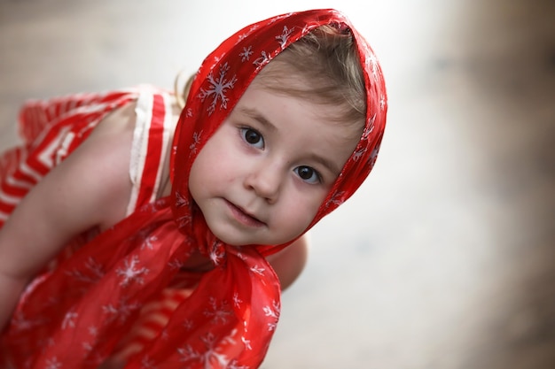 Little girl in red dresses dancing with handkerchief