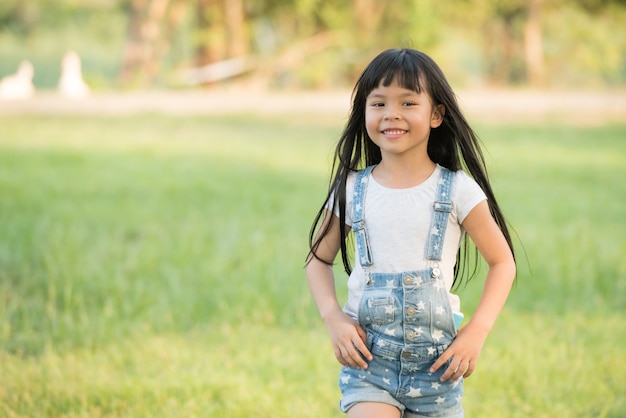 Little girl running on meadow with sunset