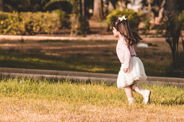 Little girl running in a park