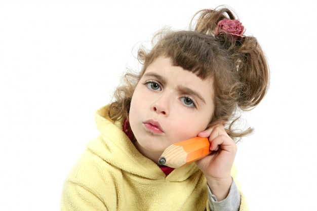 Little girl serious with big pencil in hand