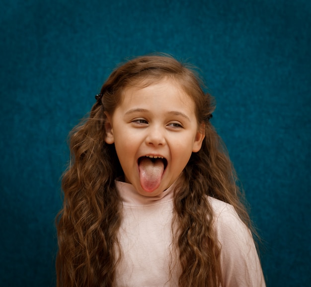 Little girl shows tongue