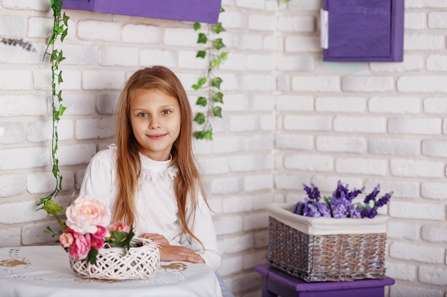 Little girl sitting on a chair